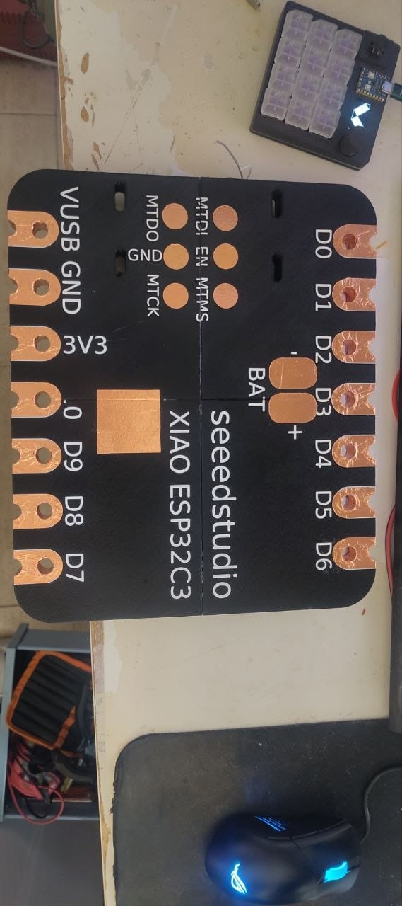 The front face of the giant XIAO, showing all pin labels (D0–D9, 3V3, GND, VUSB, BAT, MTDI, EN, MTMS...) with copper tape pads at each position.